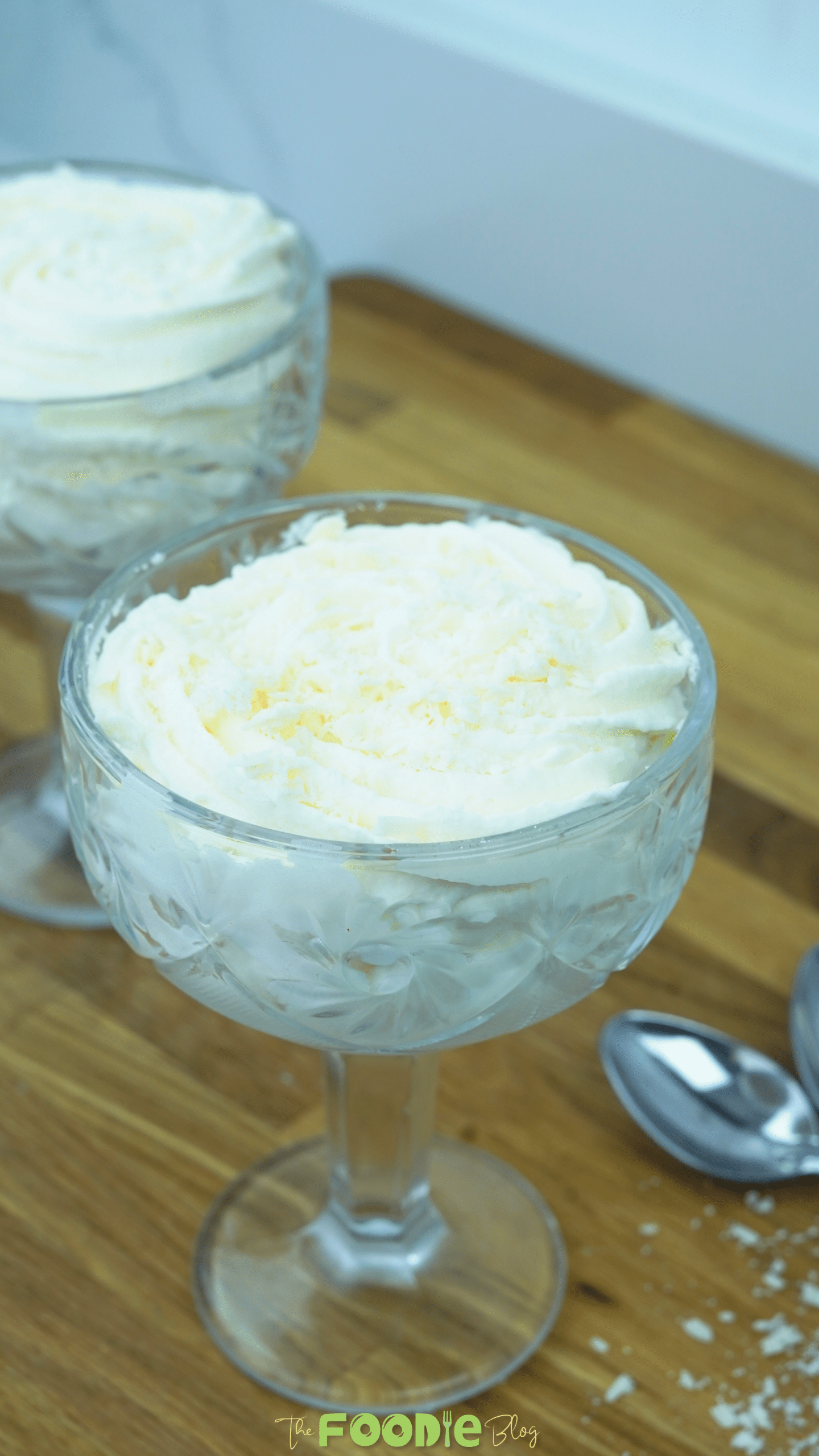 Close view of white chocolate mousse in a dessert glass with a creamy piped topping