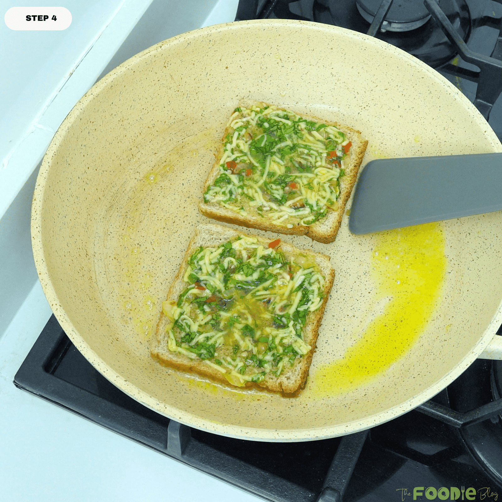 Bread omelette cooking in a skillet as the egg mixture sets and the bread starts to toast