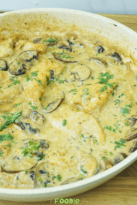 Close-up of creamy mushroom chicken with sliced mushrooms in a rich pan sauce
