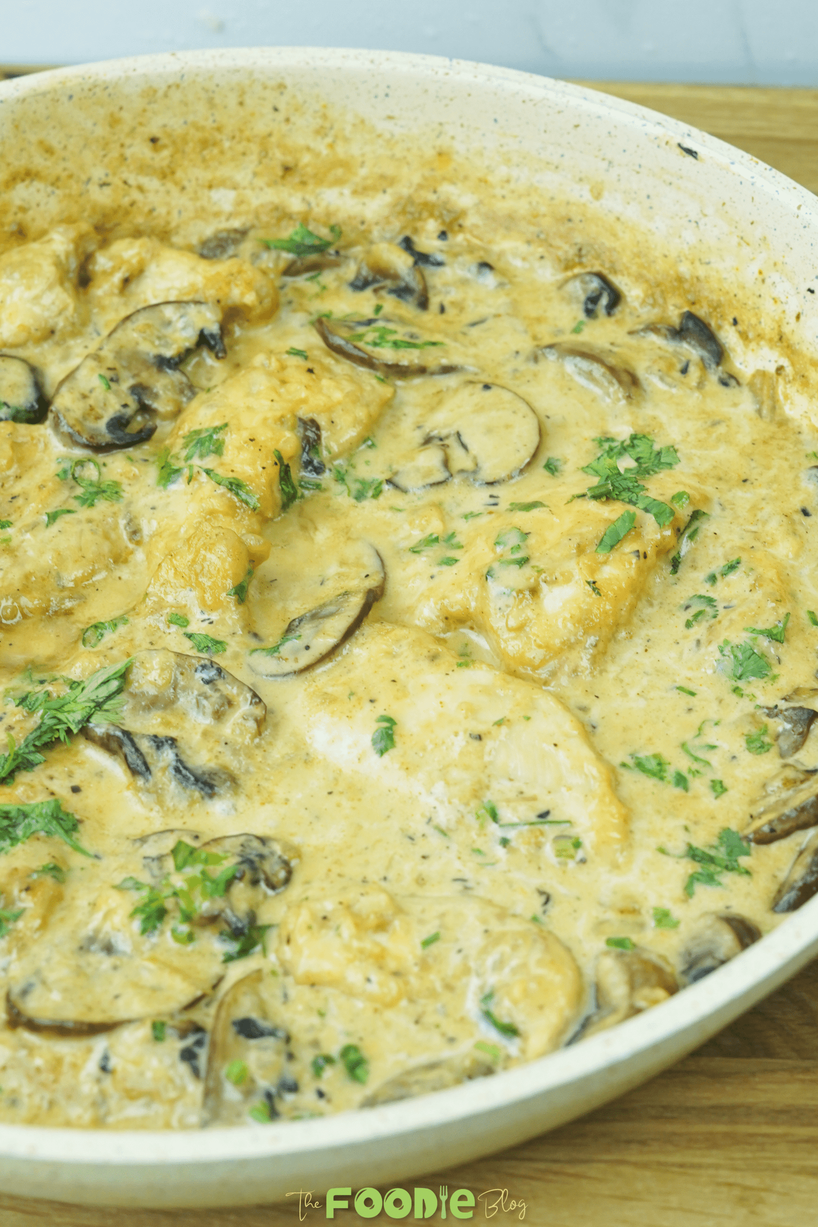 Close-up of creamy mushroom chicken with sliced mushrooms in a rich pan sauce