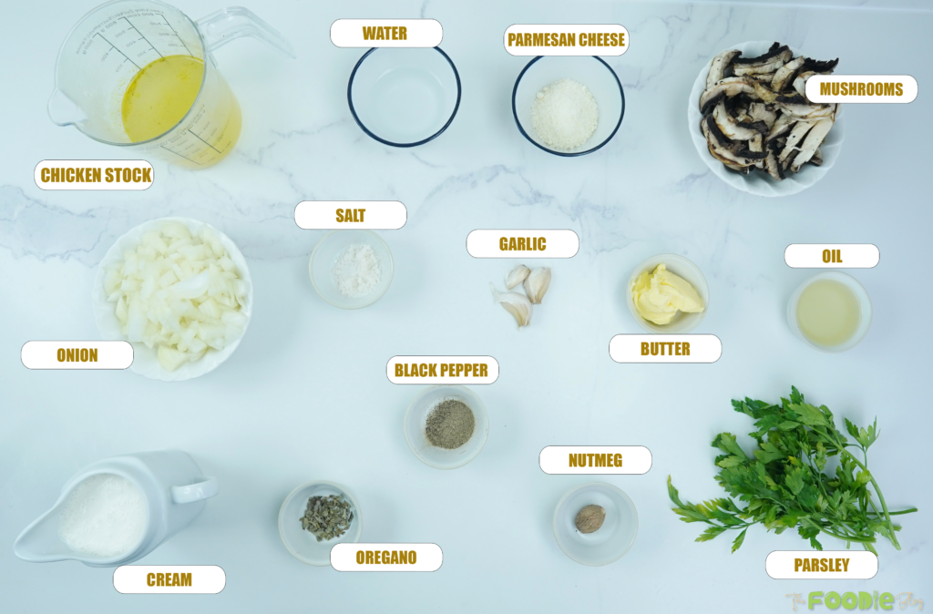 ngredients for creamy mushroom pasta arranged on a white surface including mushrooms, cream, stock, onion, garlic, Parmesan, and parsley
