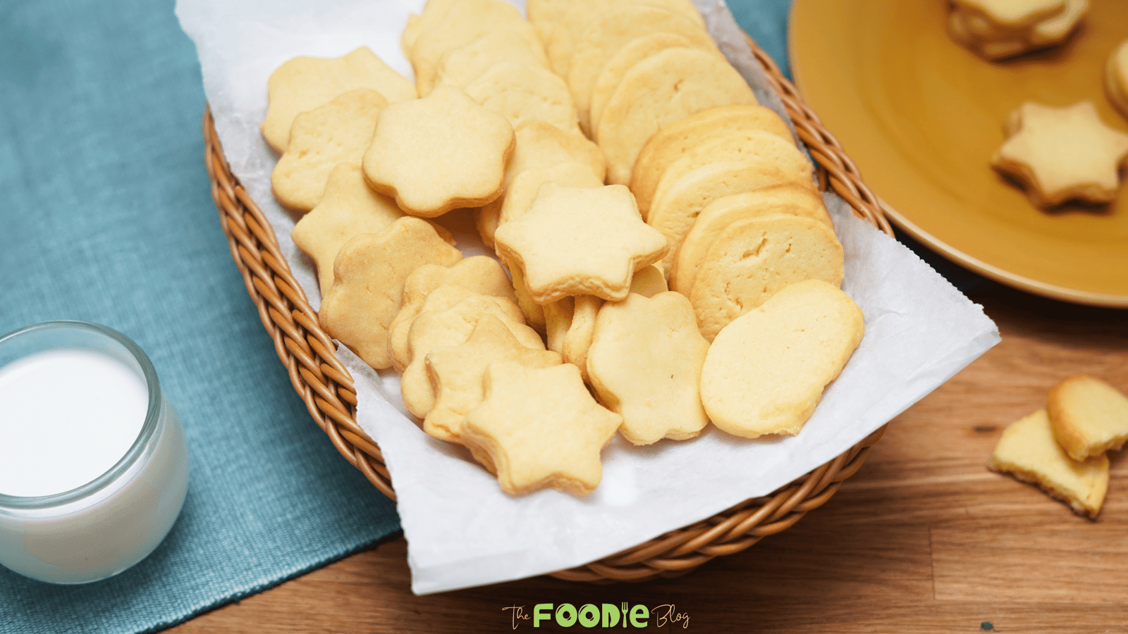 Close-up of butter cookies in star, flower, and round shapes inside a basket