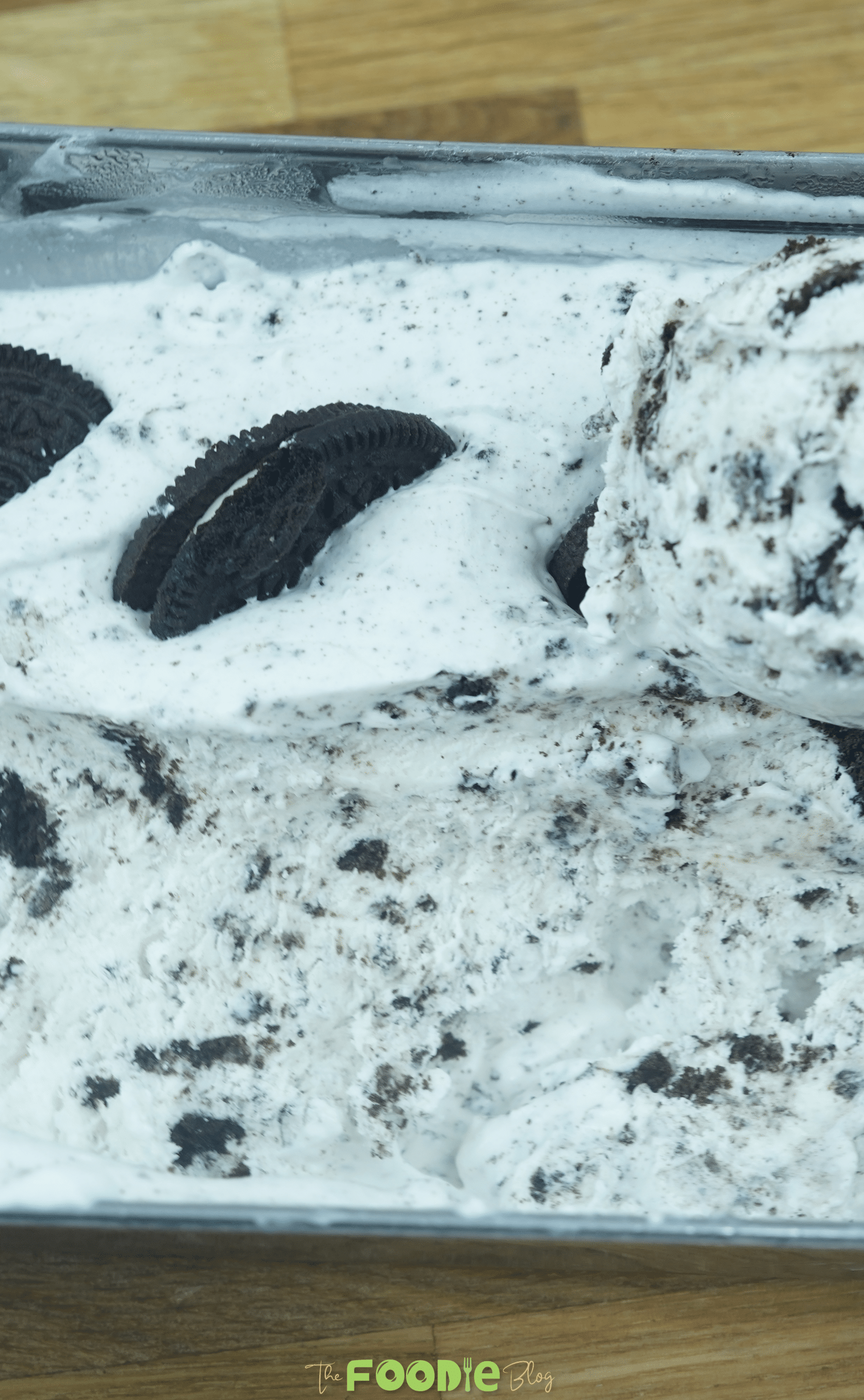 Close-up of Oreo ice cream in a loaf pan with cookie pieces and creamy cookies-and-cream texture