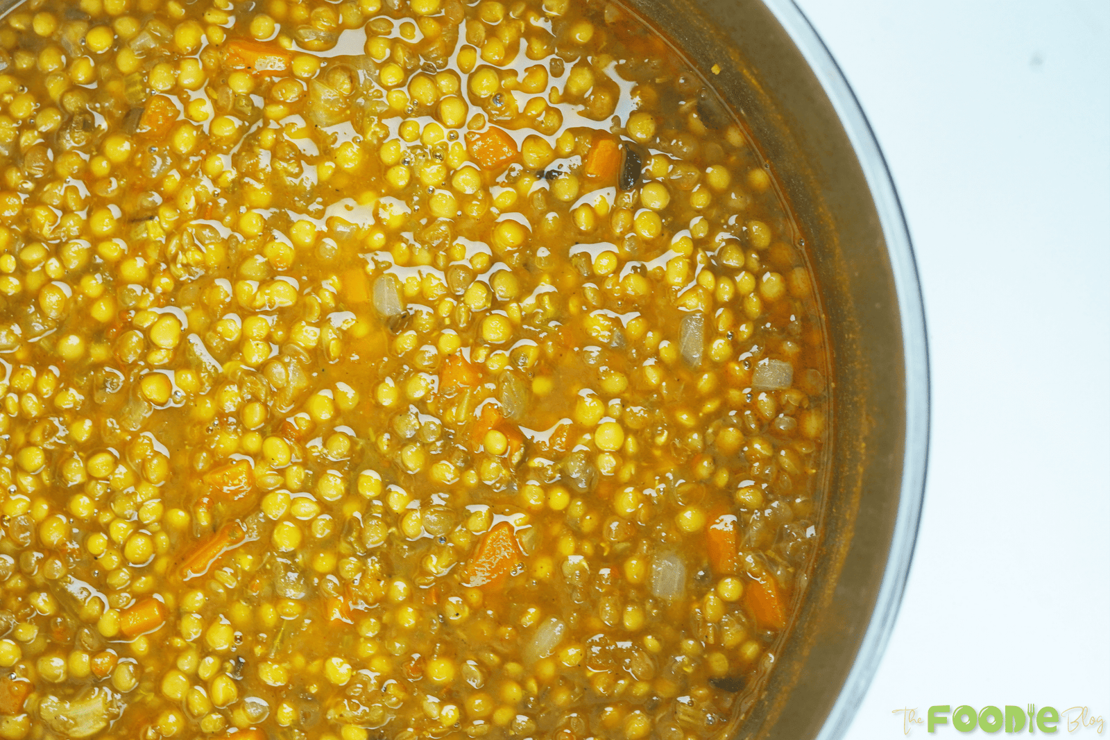 Overhead view of a bowl of vegan lentil soup with carrots and tender lentils