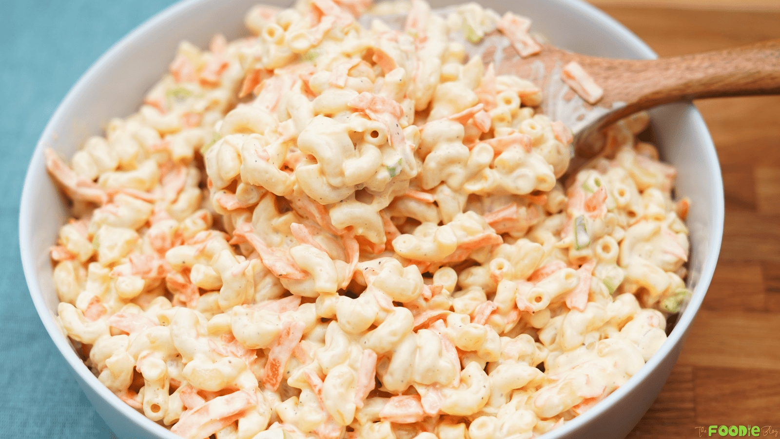 Creamy Hawaiian macaroni salad in a white bowl with shredded carrot and macaroni coated in a rich dressing