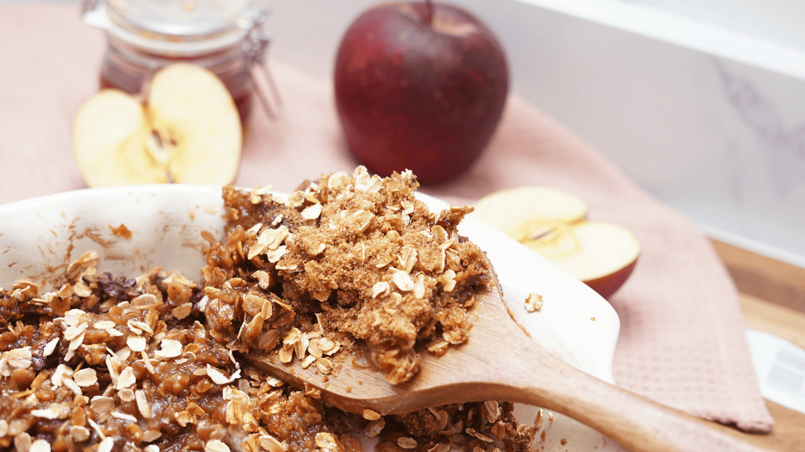 Close-up of a spoonful of healthy apple crisp with baked apples, oats, and crumb topping
