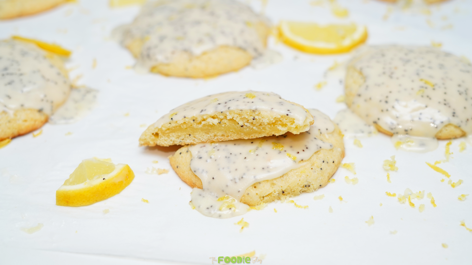 Lemon poppy seed cookie broken open to show the lemon curd filling under the glaze