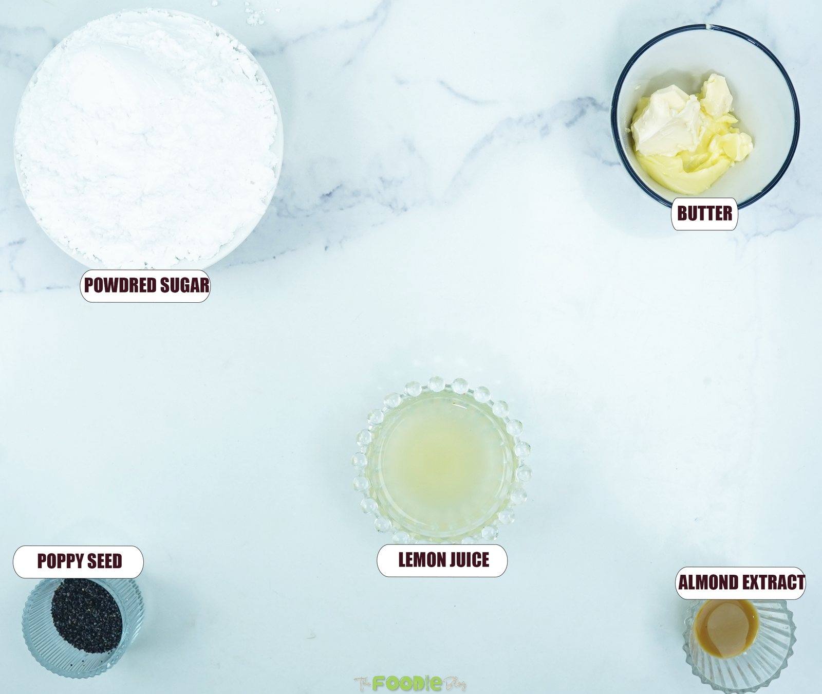 Ingredients for the lemon almond glaze including powdered sugar, butter, lemon juice, almond extract, and poppy seeds