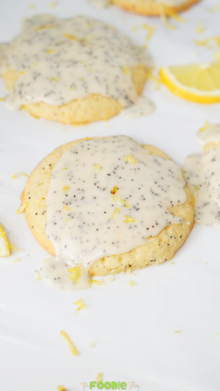 Close-up of lemon poppy seed cookies topped with thick lemon glaze and lemon zest