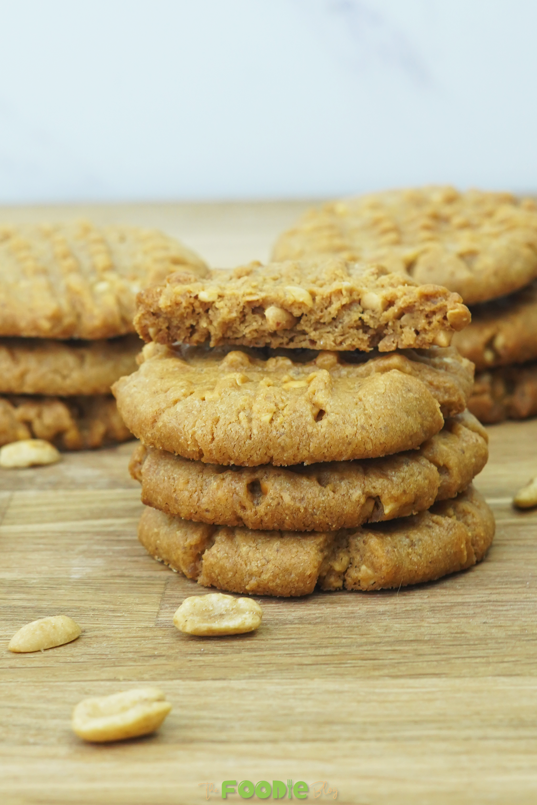 finished peanut butter cookies stacked with golden color and visible peanut pieces
