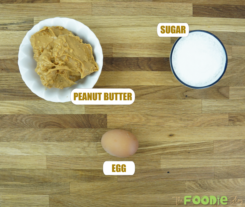 peanut butter, sugar, and egg on a wooden surface