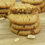 stack of soft peanut butter cookies with one broken cookie on top showing texture