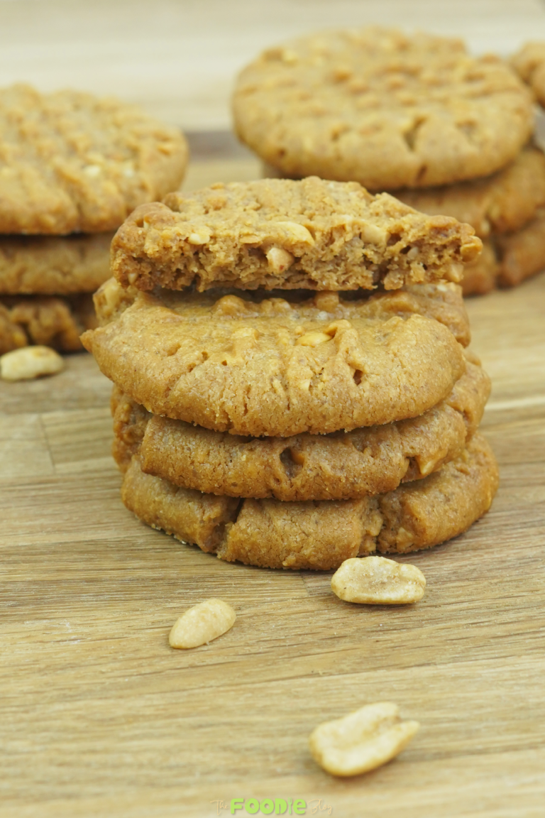 stack of soft peanut butter cookies with one broken cookie on top showing texture
