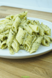 close-up side view of pesto pasta on a white plate
