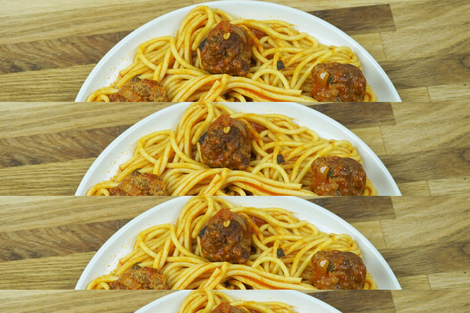 spaghetti and meatballs served on a white plate with tomato sauce