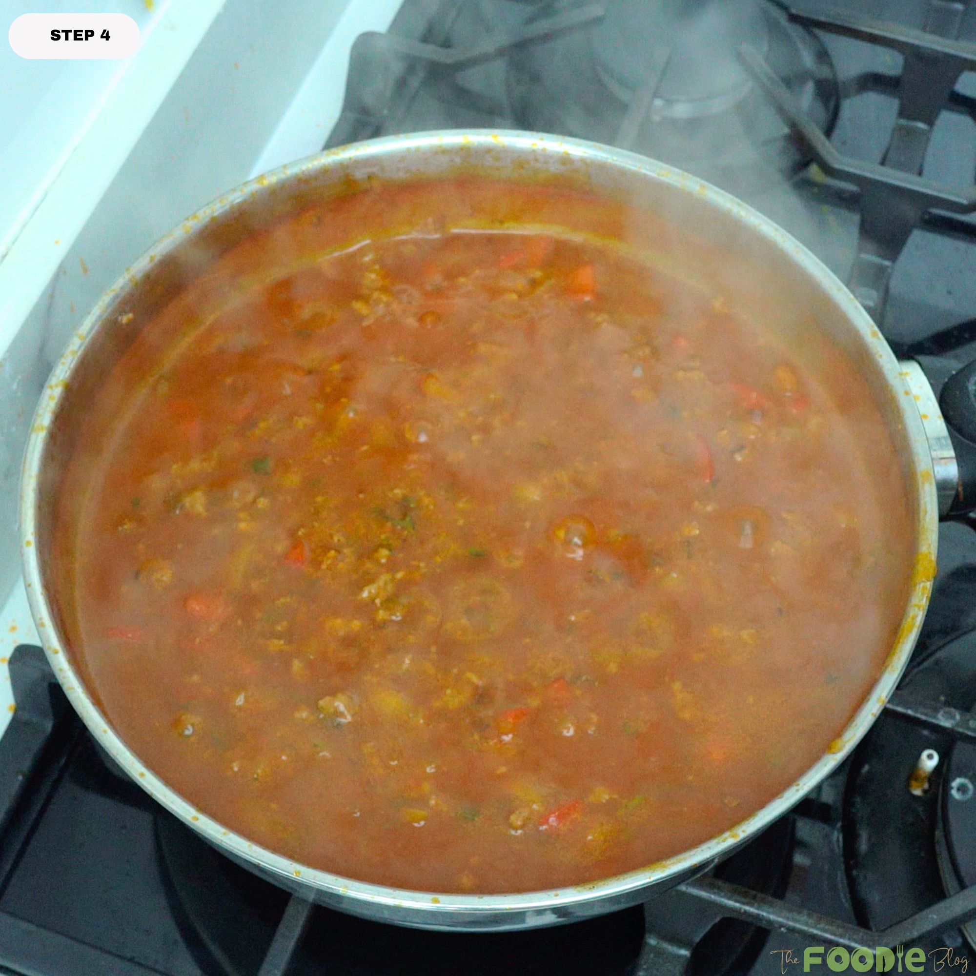 spaghetti meat sauce simmering in a skillet until thickened