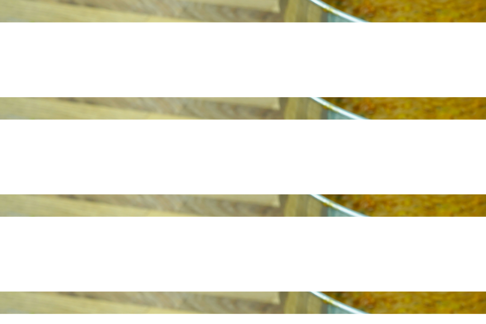 spoon lifting lentil curry from a bowl served with white rice and lemon