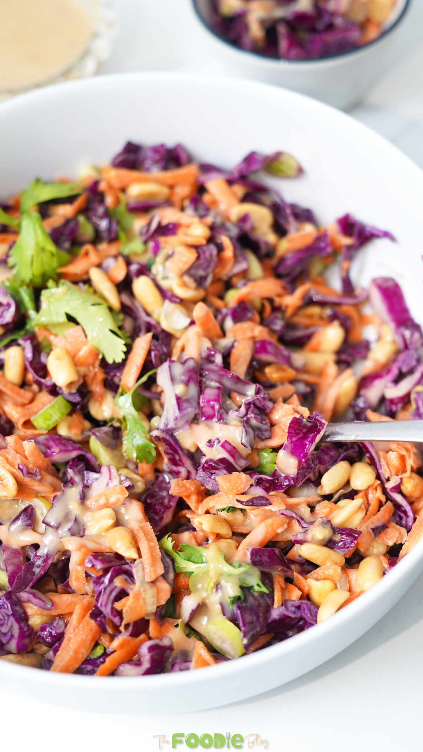 Crunchy asian slaw with purple cabbage carrots peanuts and sesame ginger dressing