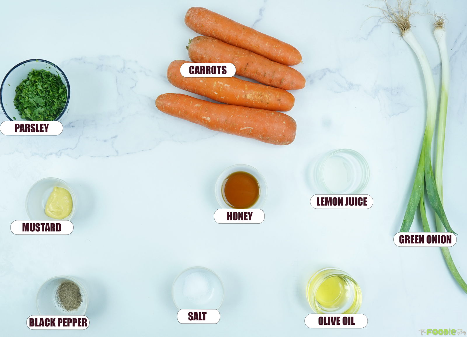 Ingredients for French carrot salad including carrots, green onion, parsley, Dijon mustard, honey, lemon juice, olive oil, salt, and black pepper.