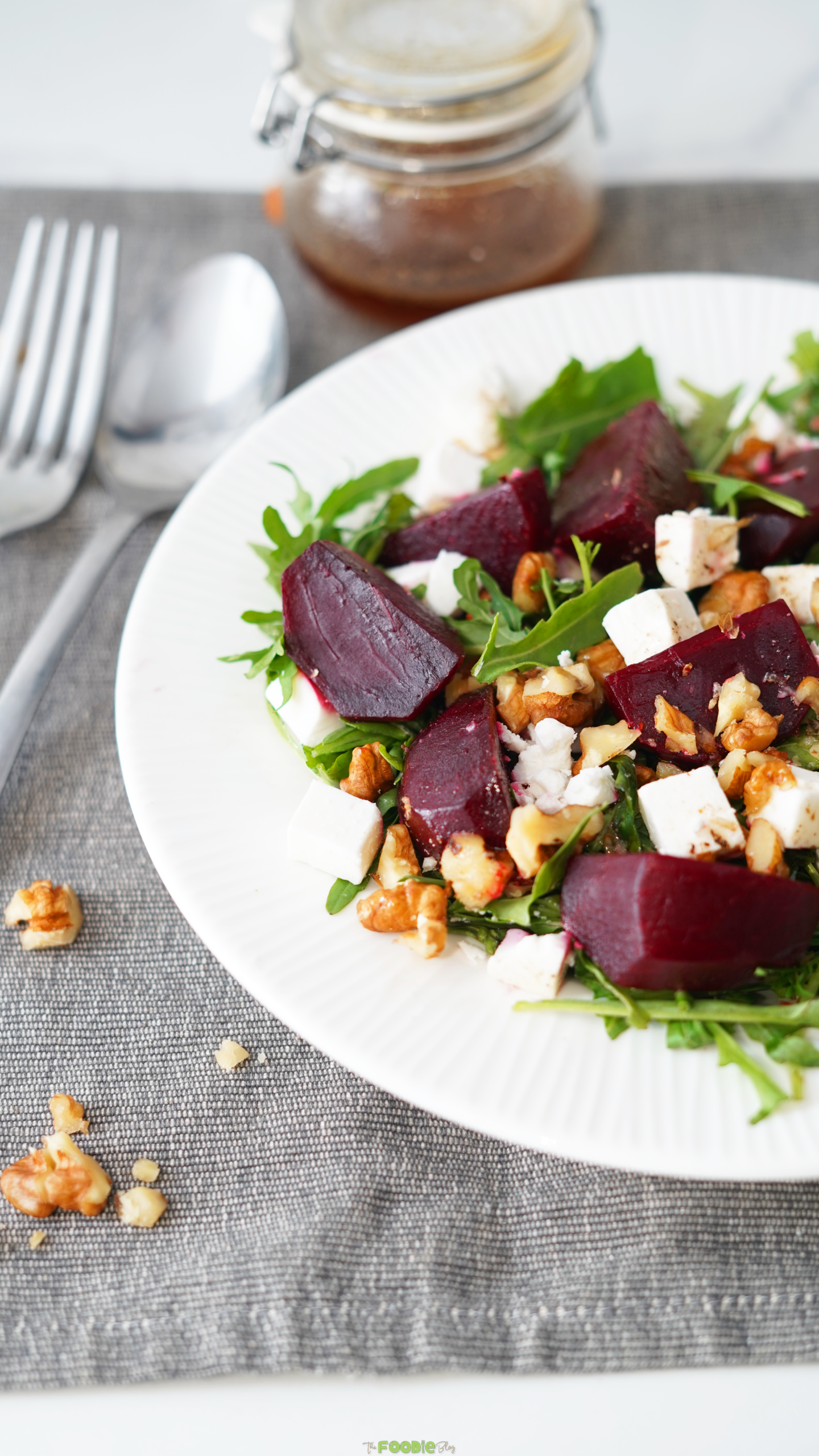Arugula salad with beet pieces, feta, walnuts, and balsamic dressing.