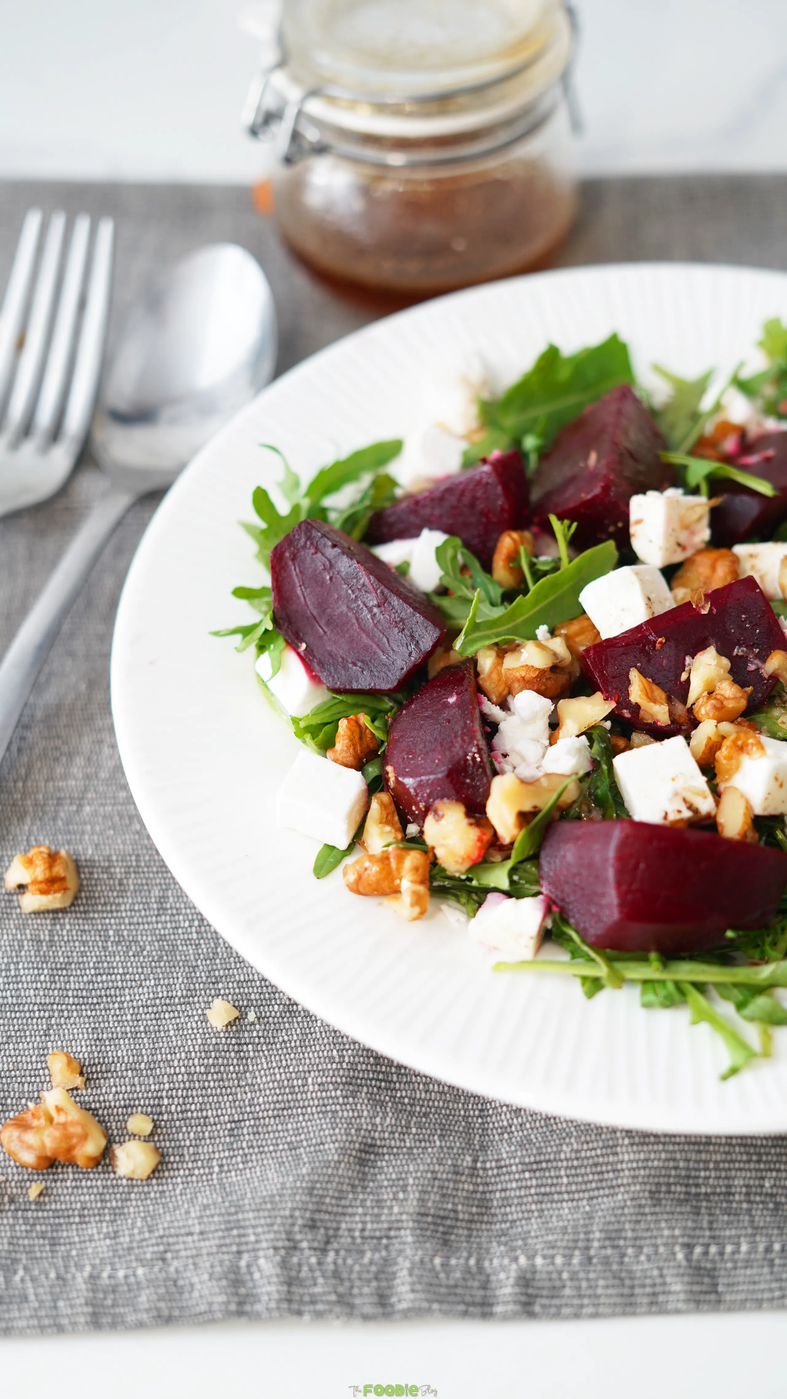 Arugula salad with beet pieces, feta, walnuts, and balsamic dressing.