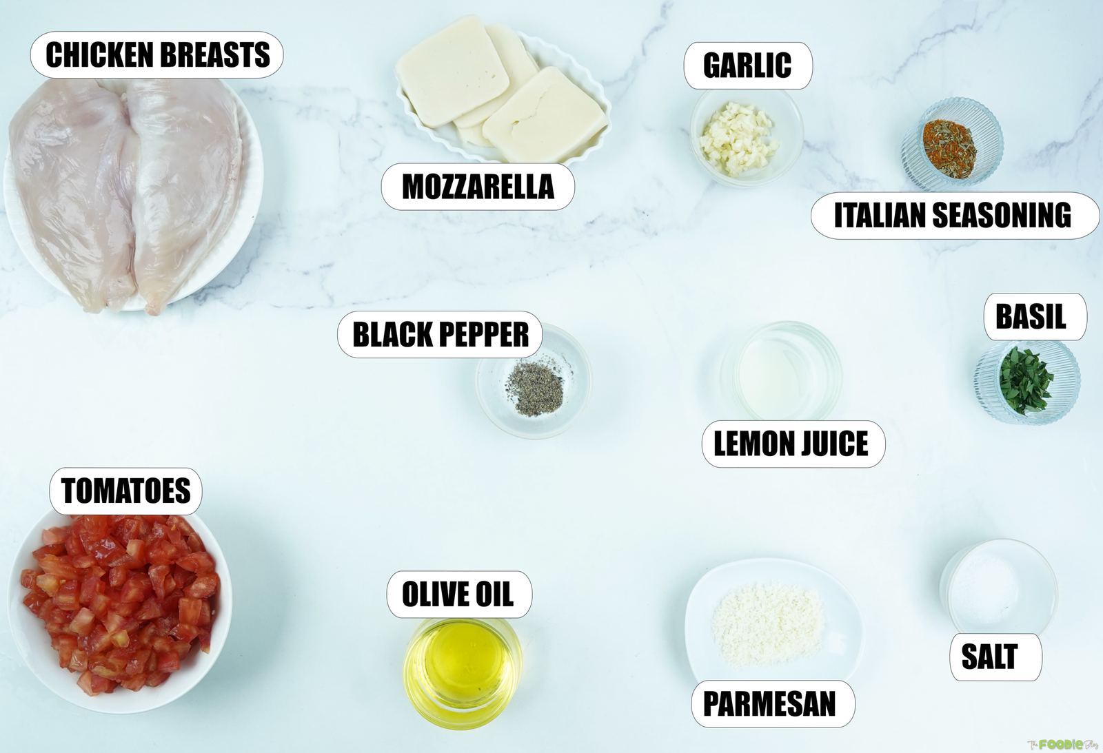 Ingredients for Bruschetta Chicken including chicken breasts, mozzarella, tomatoes, garlic, basil, Parmesan, lemon juice, olive oil, and seasonings.