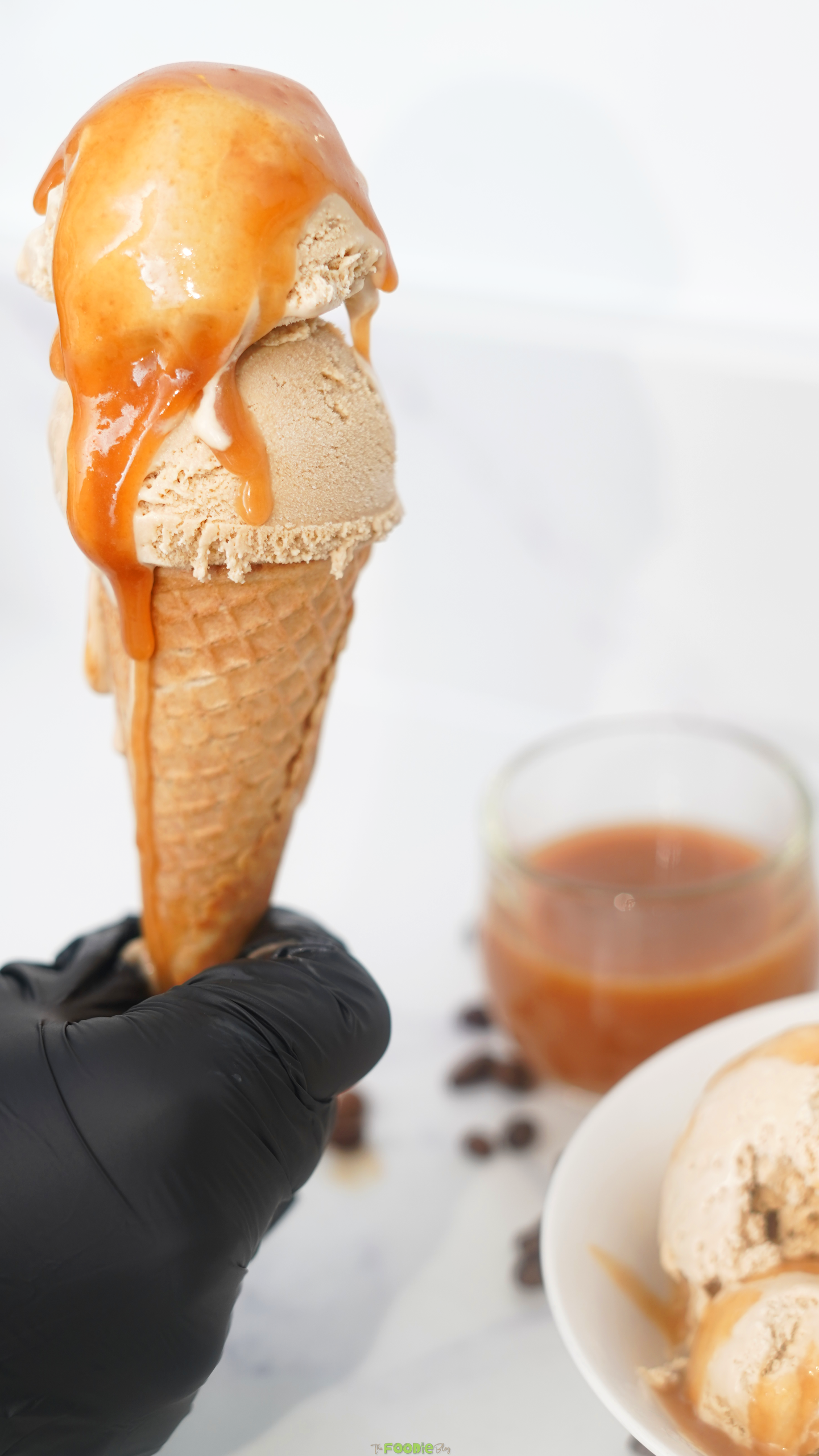 Coffee ice cream recipe served in a waffle cone with salted caramel sauce.