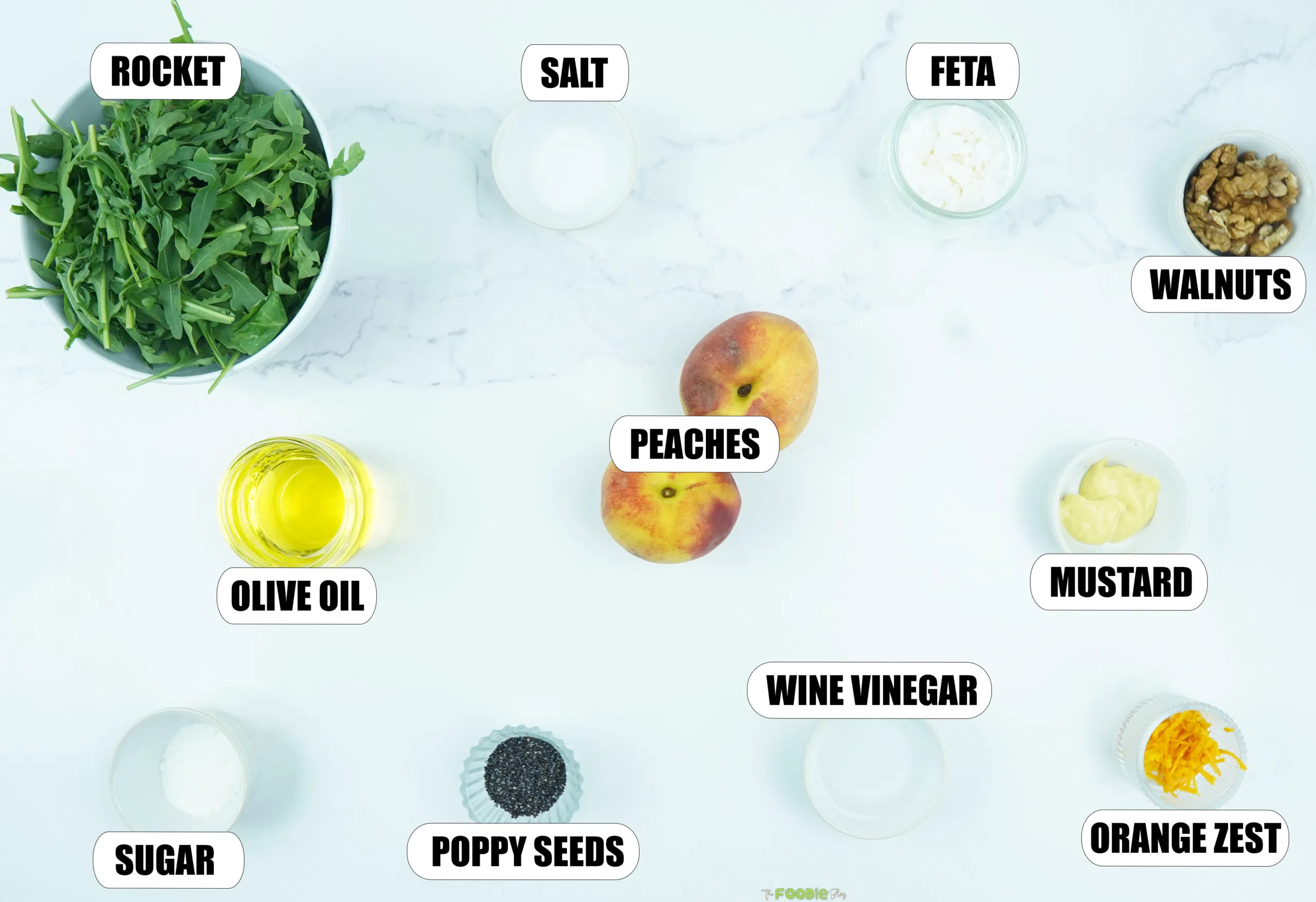 Ingredients for peach salad with arugula, peaches, feta, walnuts, olive oil, poppy seeds, mustard, vinegar, orange zest, sugar, and salt.