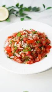 Close-up of fresh Pico de Gallo with tomatoes, white onion, cilantro, and jalapeño.