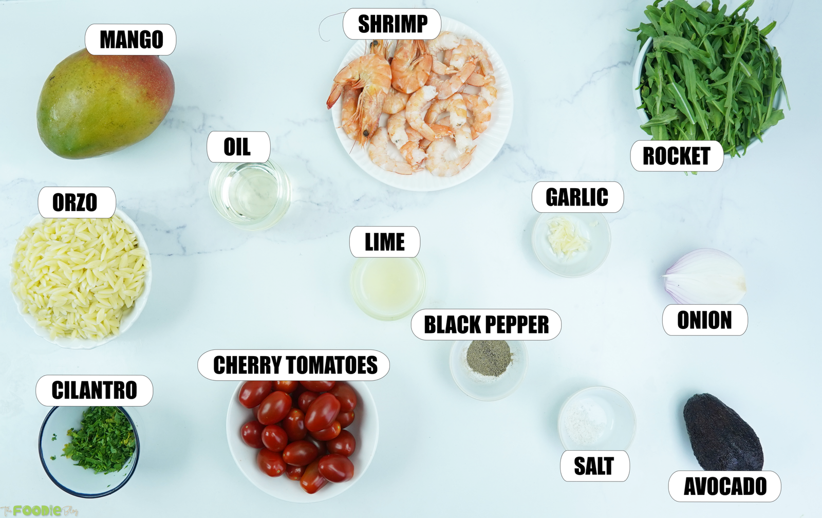 Ingredients for prawn mango avocado summer salad including shrimp, mango, orzo, arugula, avocado, cherry tomatoes, onion, cilantro, lime, garlic, oil, salt, and black pepper.