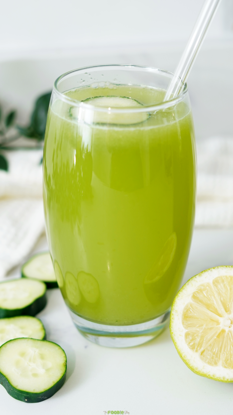 Close-up of a glass of refreshing cucumber lemonade with fresh cucumber slices and lemon.