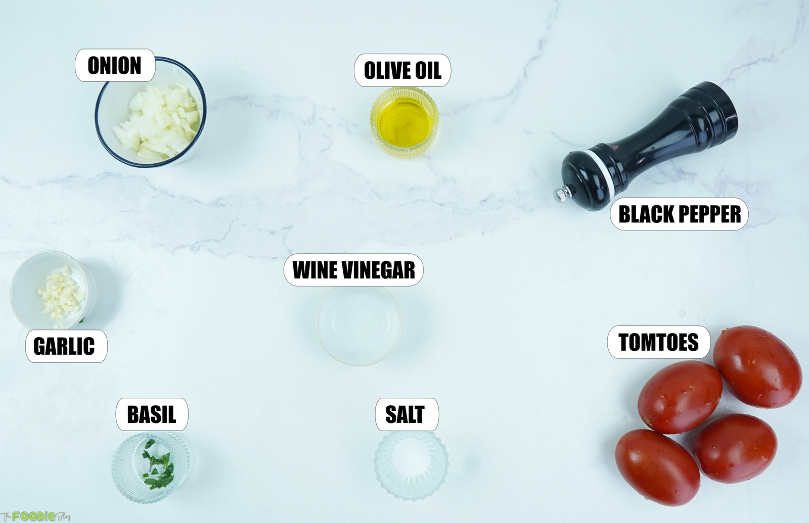 Tomatoes, onion, garlic, basil, olive oil, white wine vinegar, salt, and pepper for tomato salad.