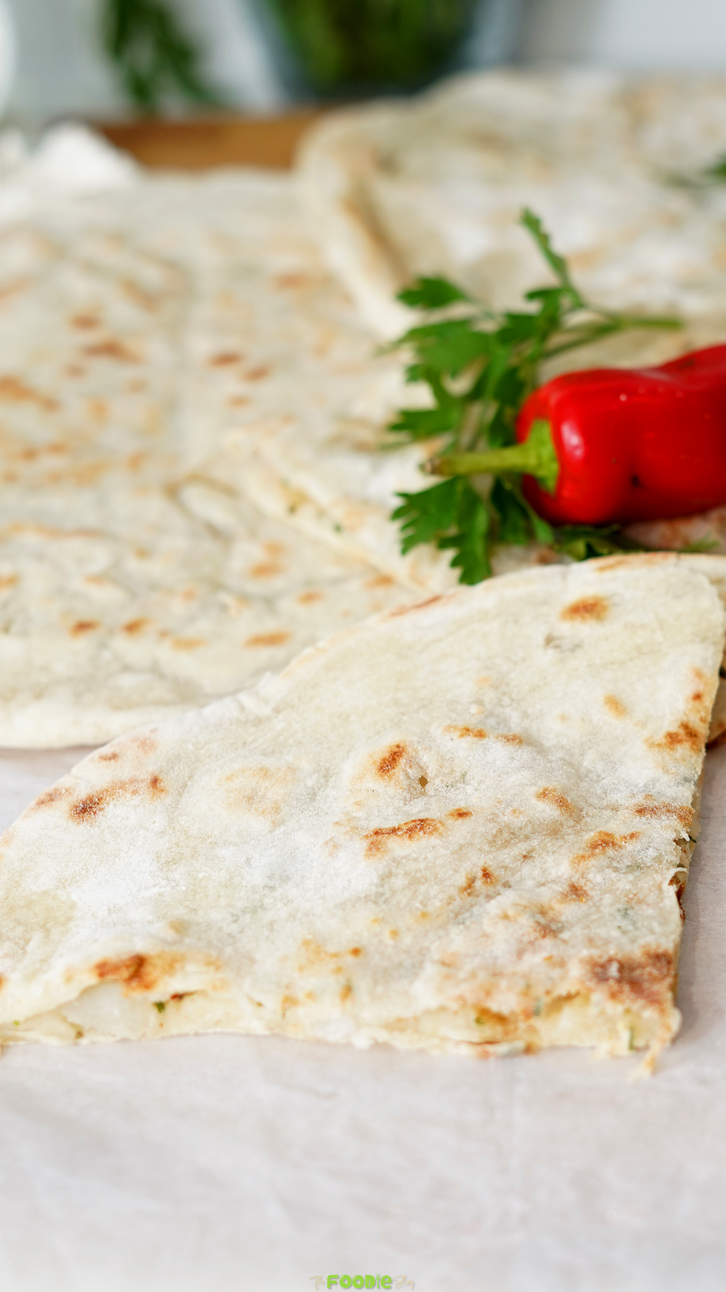 Close-up of soft Aloo Paratha with light golden spots and potato filling inside.