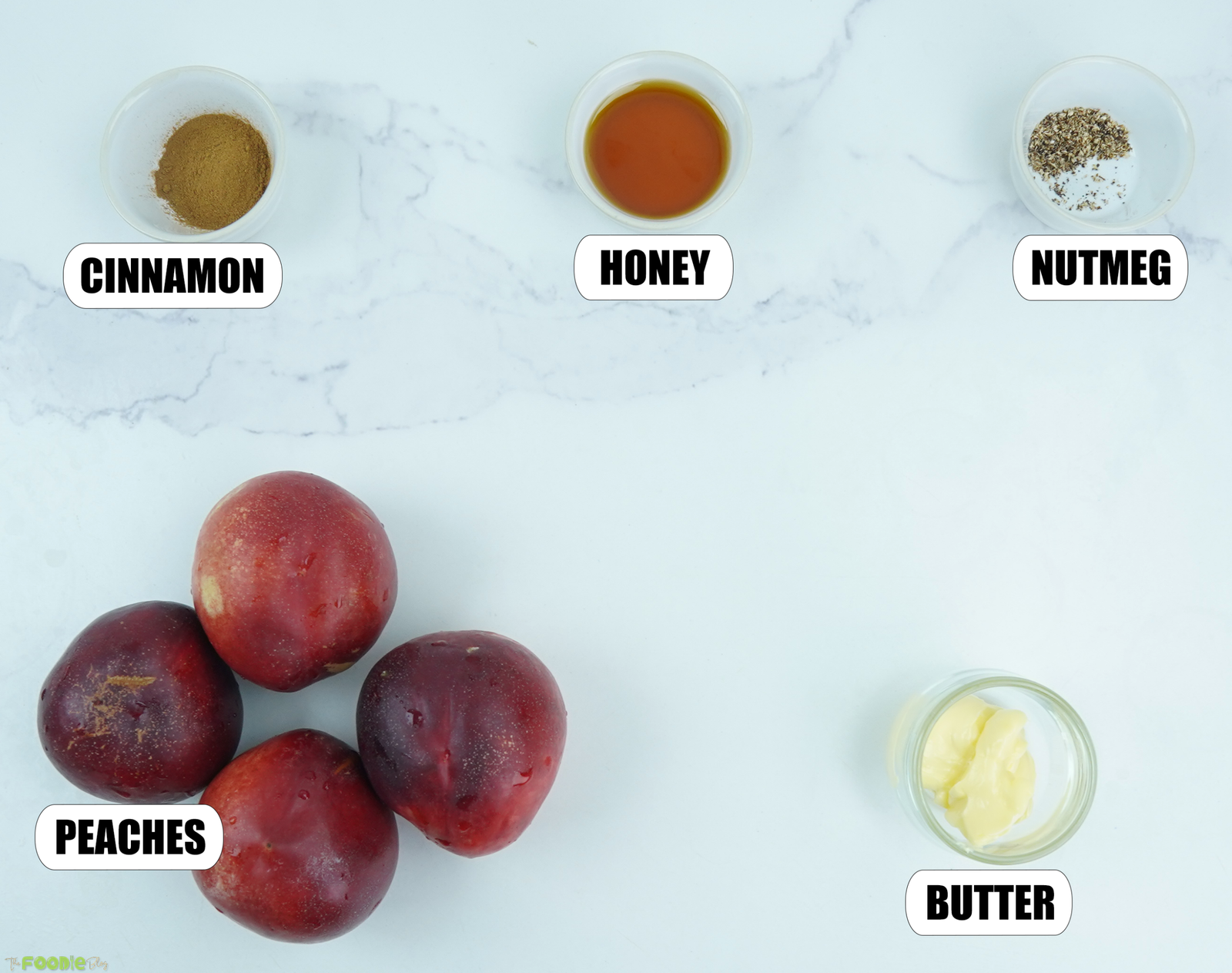 Fresh peaches, honey, butter, cinnamon, and nutmeg for making baked peaches.