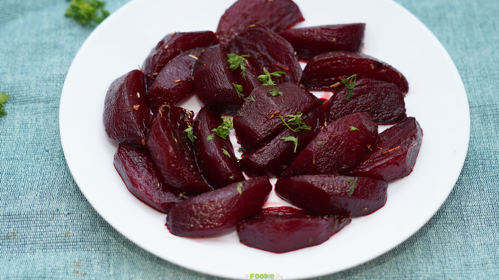 Balsamic Glazed Beetroot served on a white plate with thyme leaves and a glossy balsamic coating.
