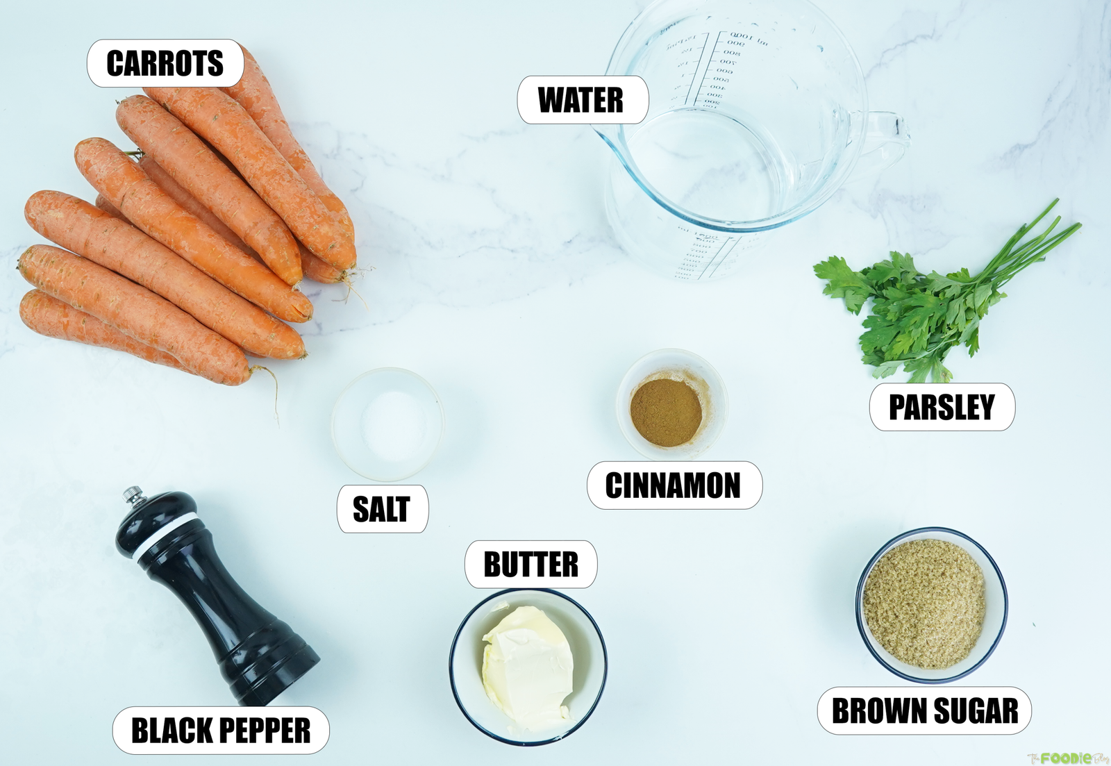 Ingredients for Candied Carrots Recipe with carrots, water, butter, brown sugar, cinnamon, salt, black pepper, and parsley.