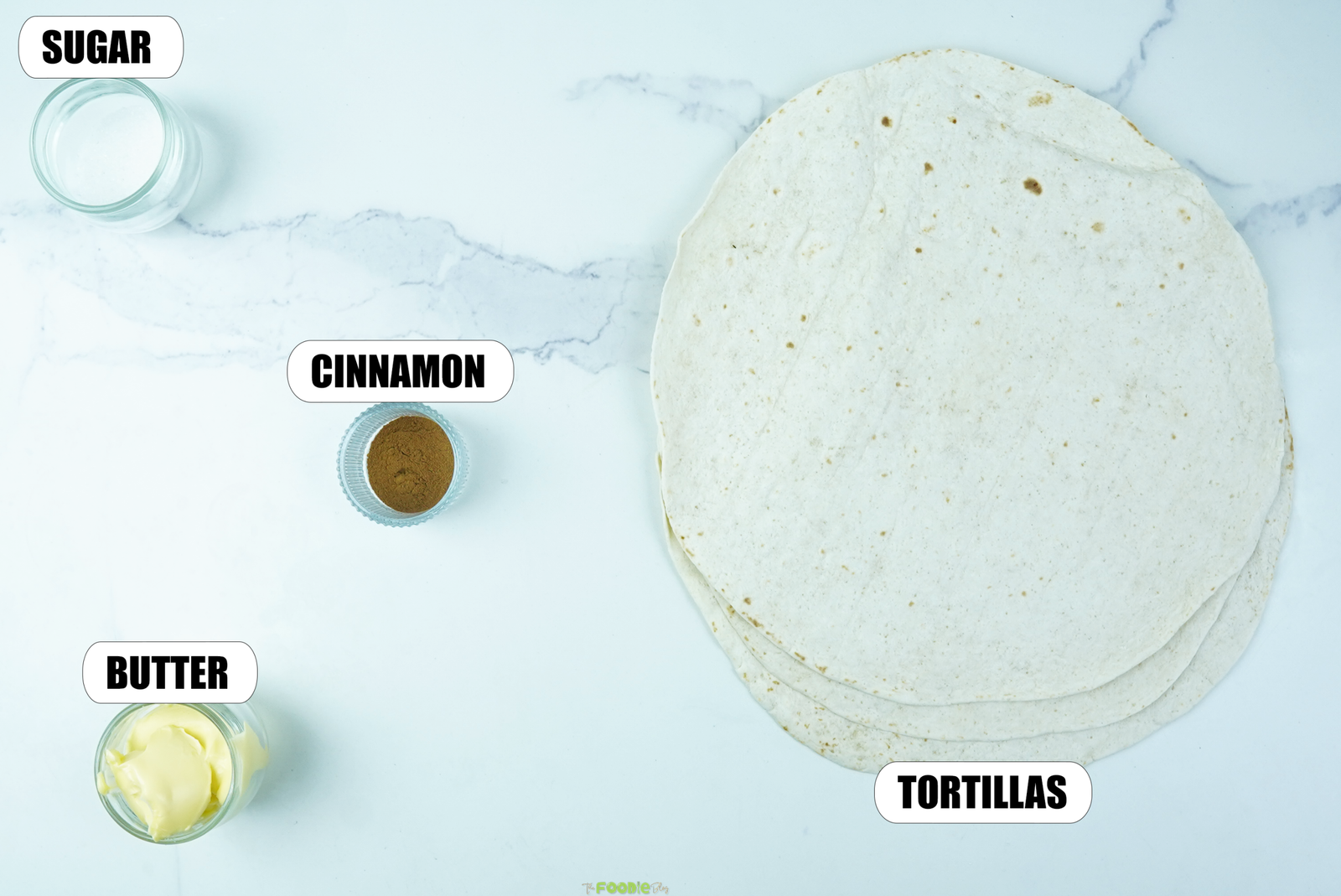 Flour tortillas, butter, cinnamon, and sugar arranged for cinnamon sugar tortilla crisps.