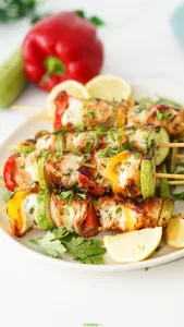 Easy Chicken Kabobs with grilled chicken, zucchini, bell peppers, onion, parsley, and lemon.