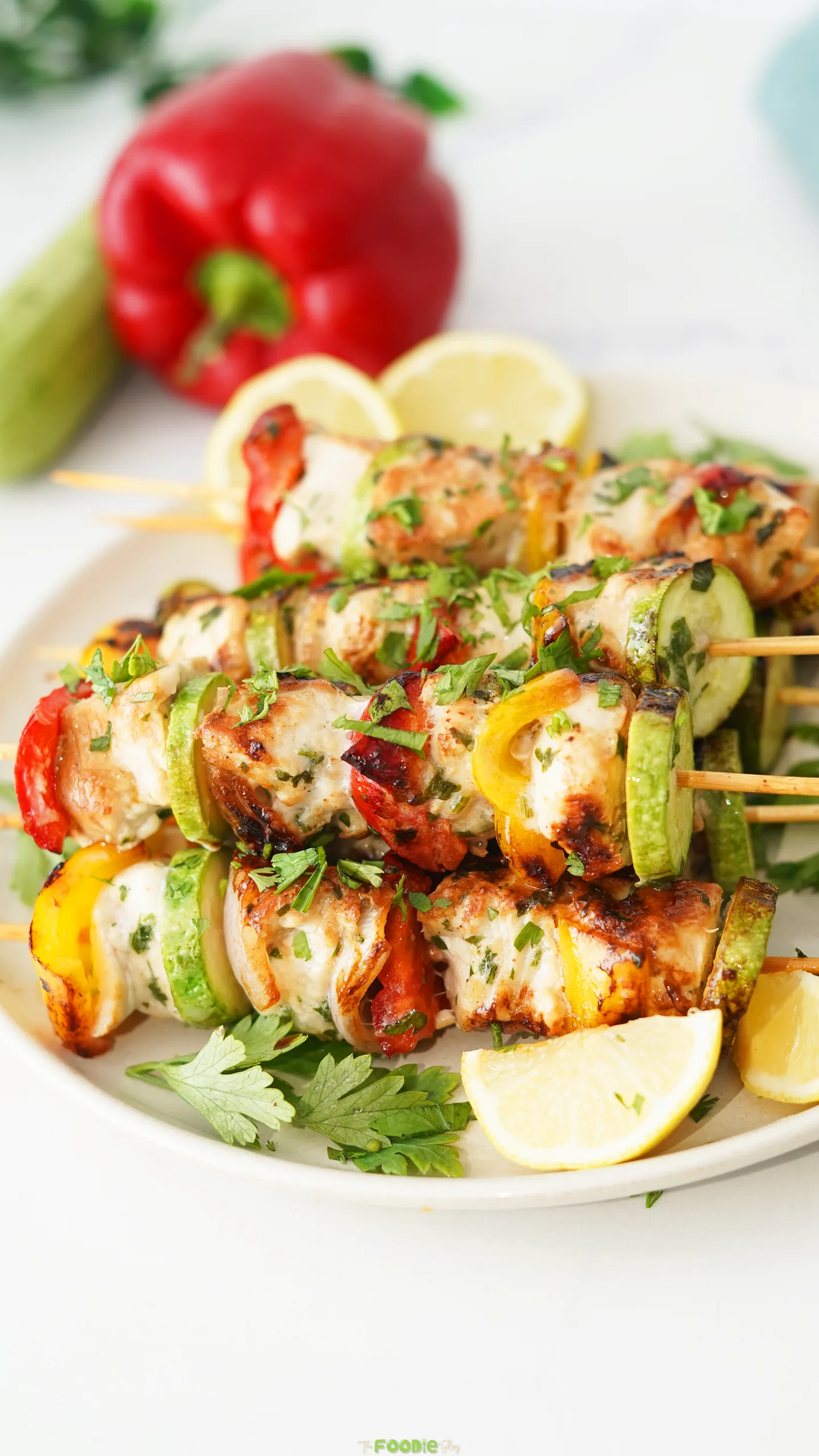 Easy Chicken Kabobs with grilled chicken, zucchini, bell peppers, onion, parsley, and lemon.