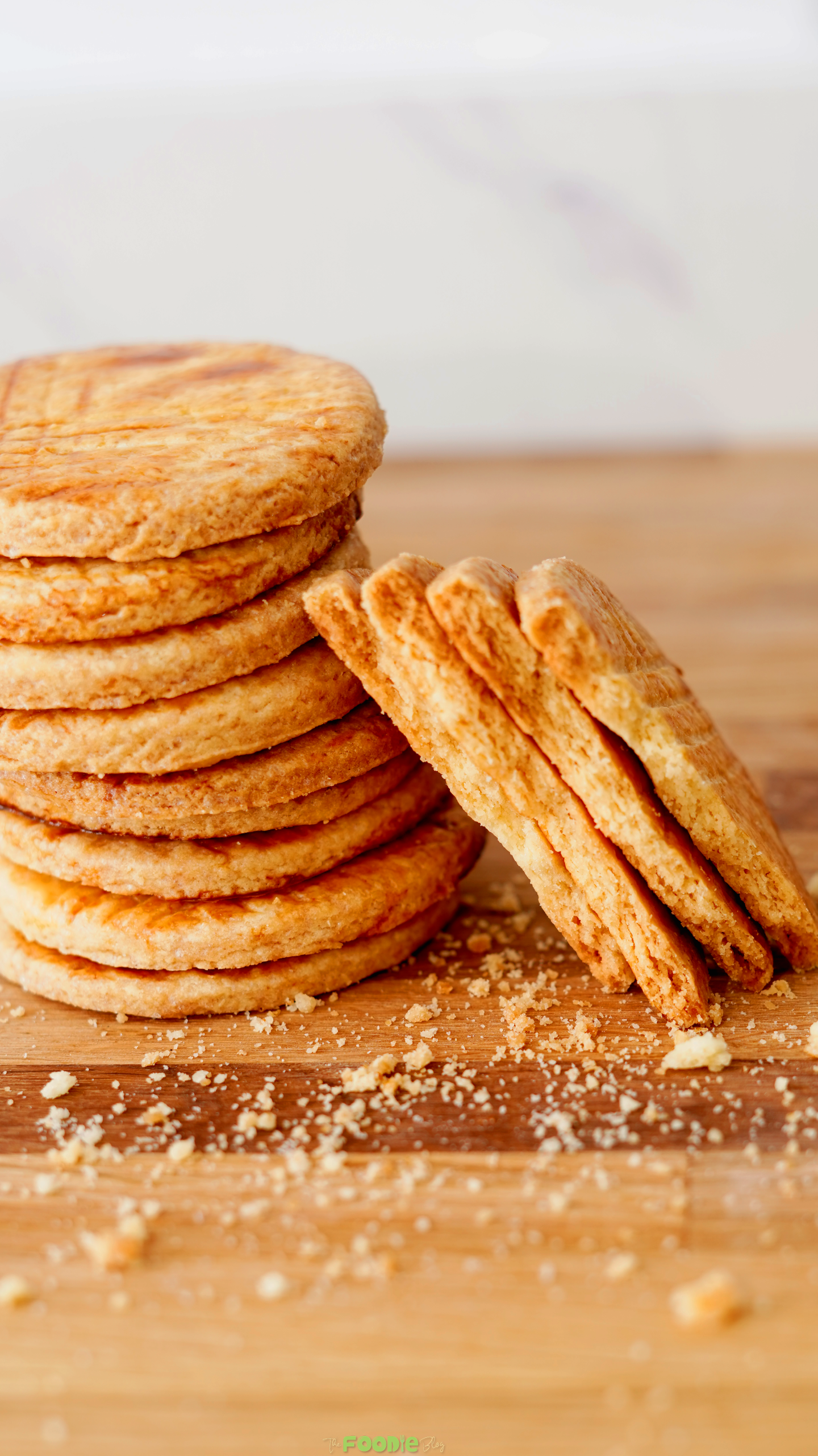Stack of buttery Galettes Bretonnes with one broken cookie showing the crisp texture.