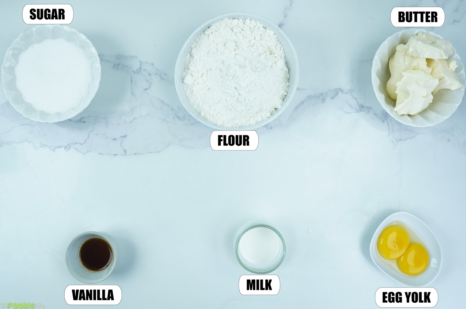 Ingredients for Galettes Bretonnes with flour, sugar, butter, vanilla, milk, and egg yolks.
