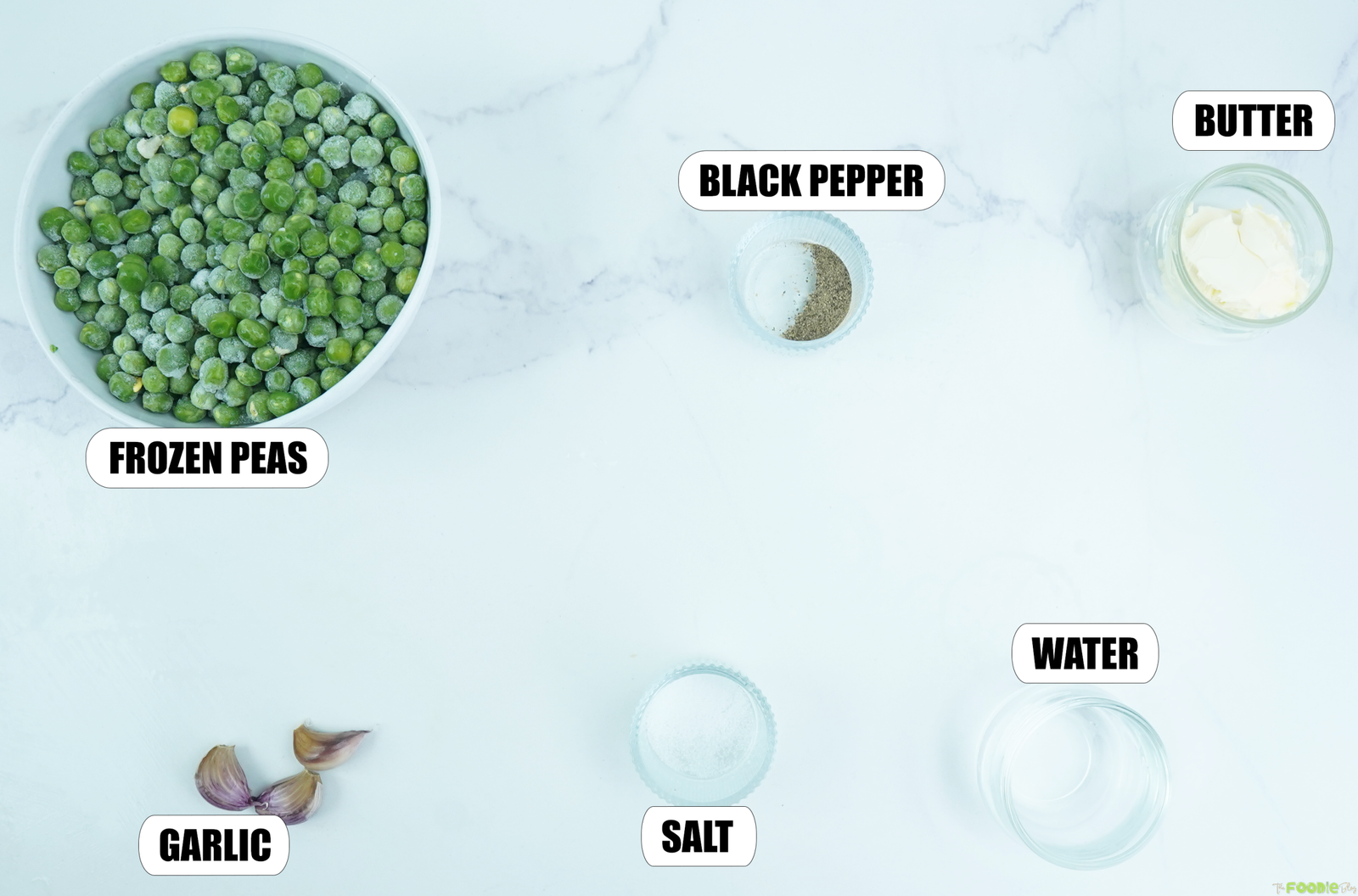 Frozen peas, butter, garlic, salt, black pepper, and water arranged for garlic buttered peas.
