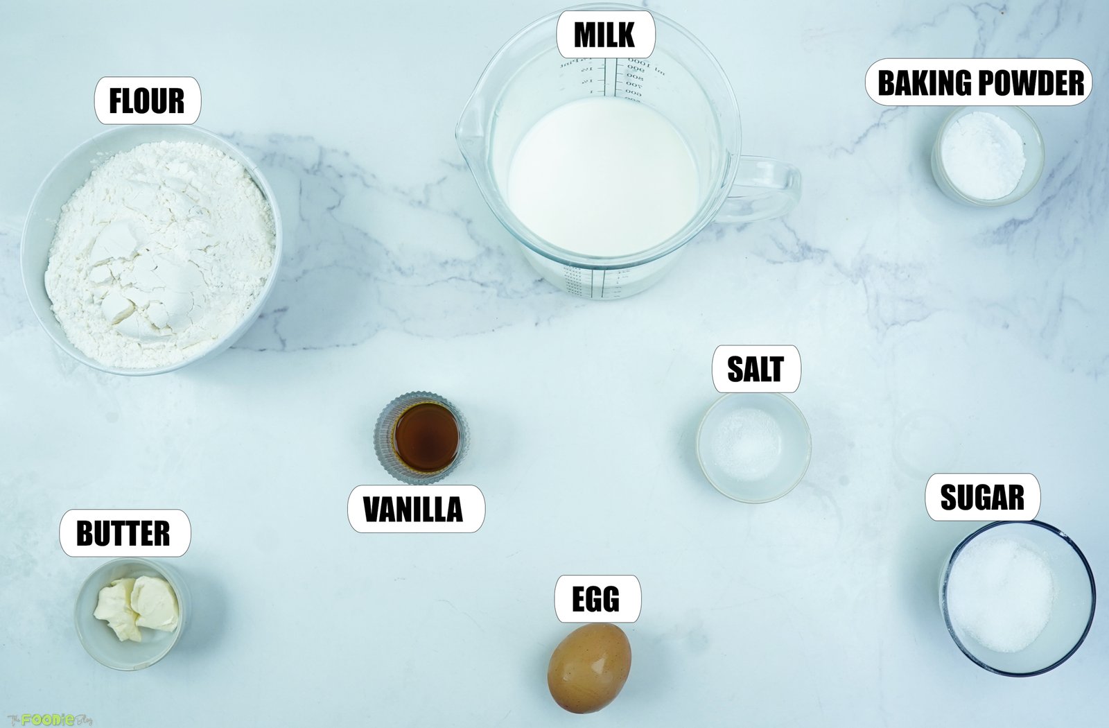 Flour, milk, baking powder, sugar, butter, egg, vanilla, and salt for Giant Pancakes.