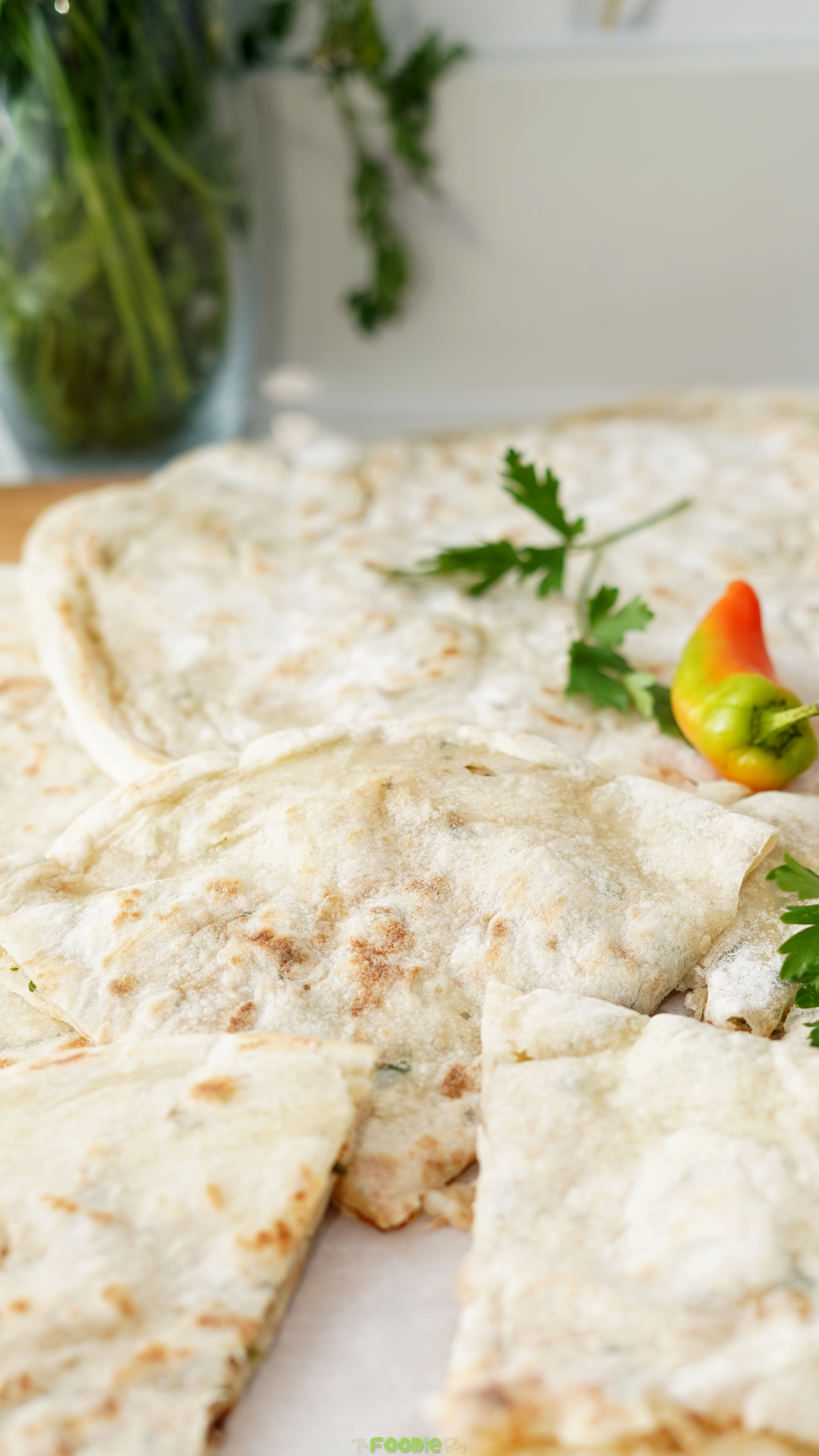 Homemade Aloo Paratha served warm with cilantro and chili garnish.