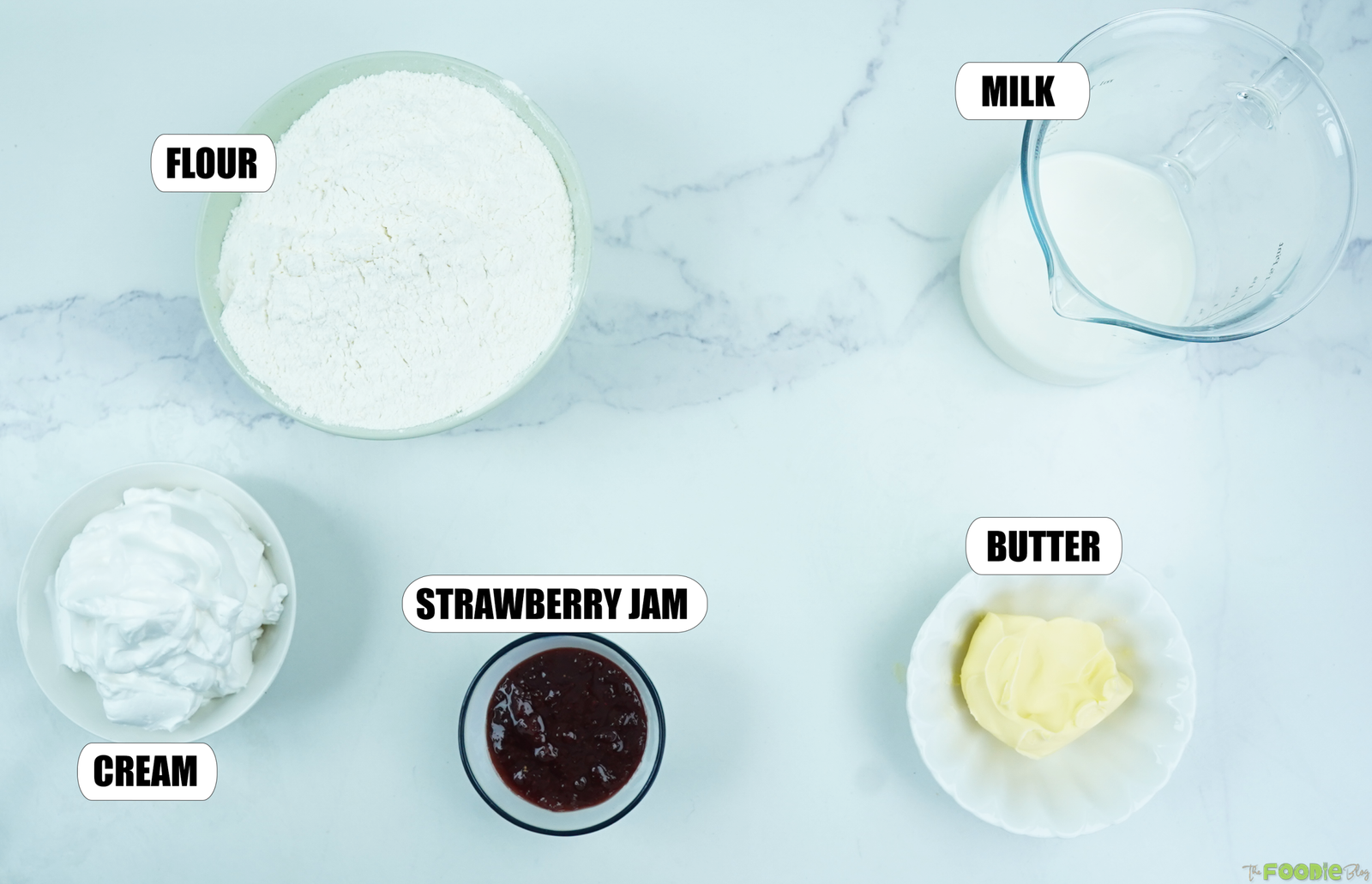 Self-rising flour, cold milk, salted butter, strawberry jam, and whipping cream for homemade scones.