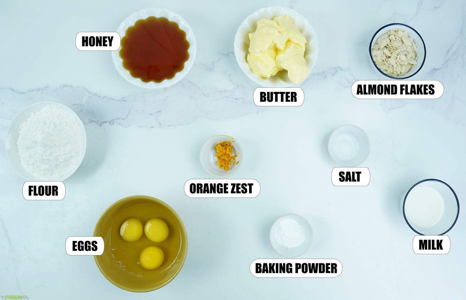 Honey, butter, flour, eggs, milk, sliced almonds, orange zest, salt, and baking powder for Honey Cake.