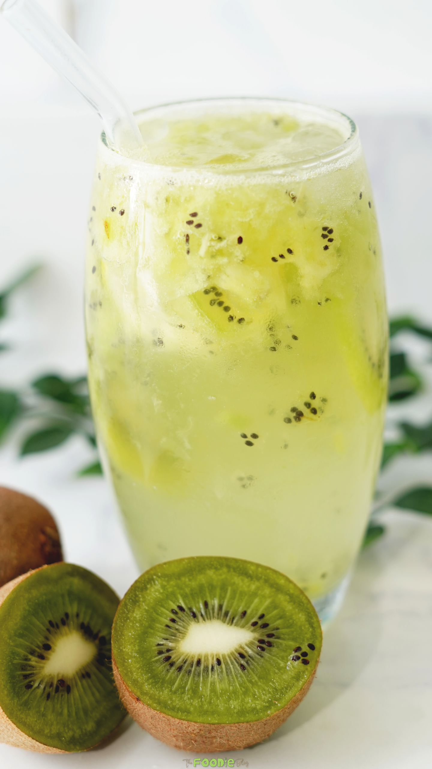 Fizzy kiwi drink made with fresh kiwi, lime juice, sugar, and Sprite in a tall glass.