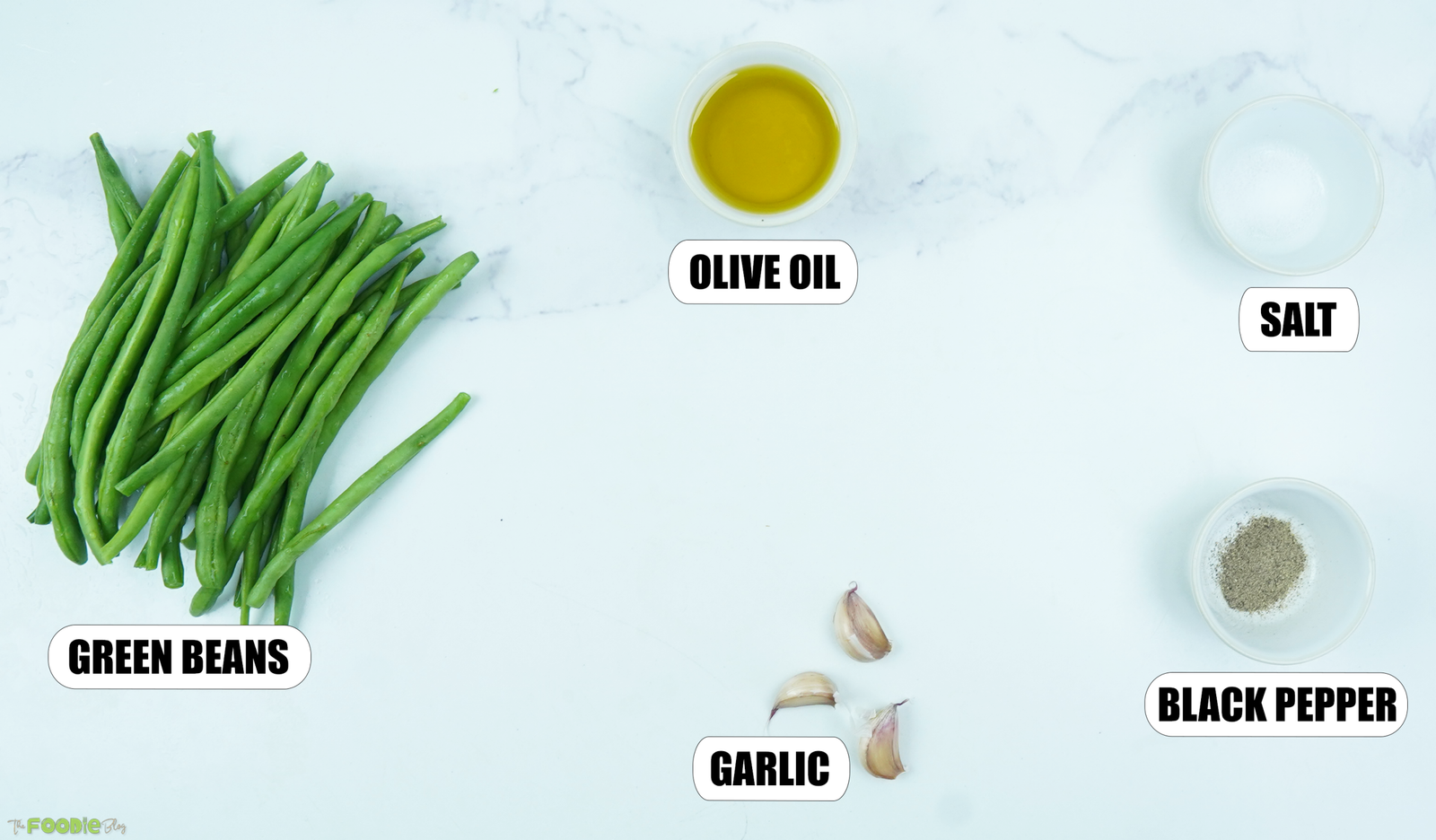 Fresh green beans, olive oil, garlic, salt, and black pepper arranged for sautéed green beans with garlic.