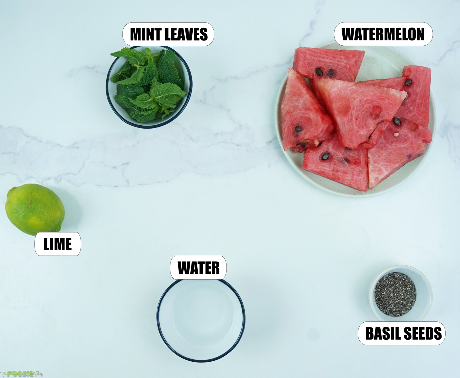 Watermelon, mint leaves, lime, water, and basil seeds for making watermelon lemonade.