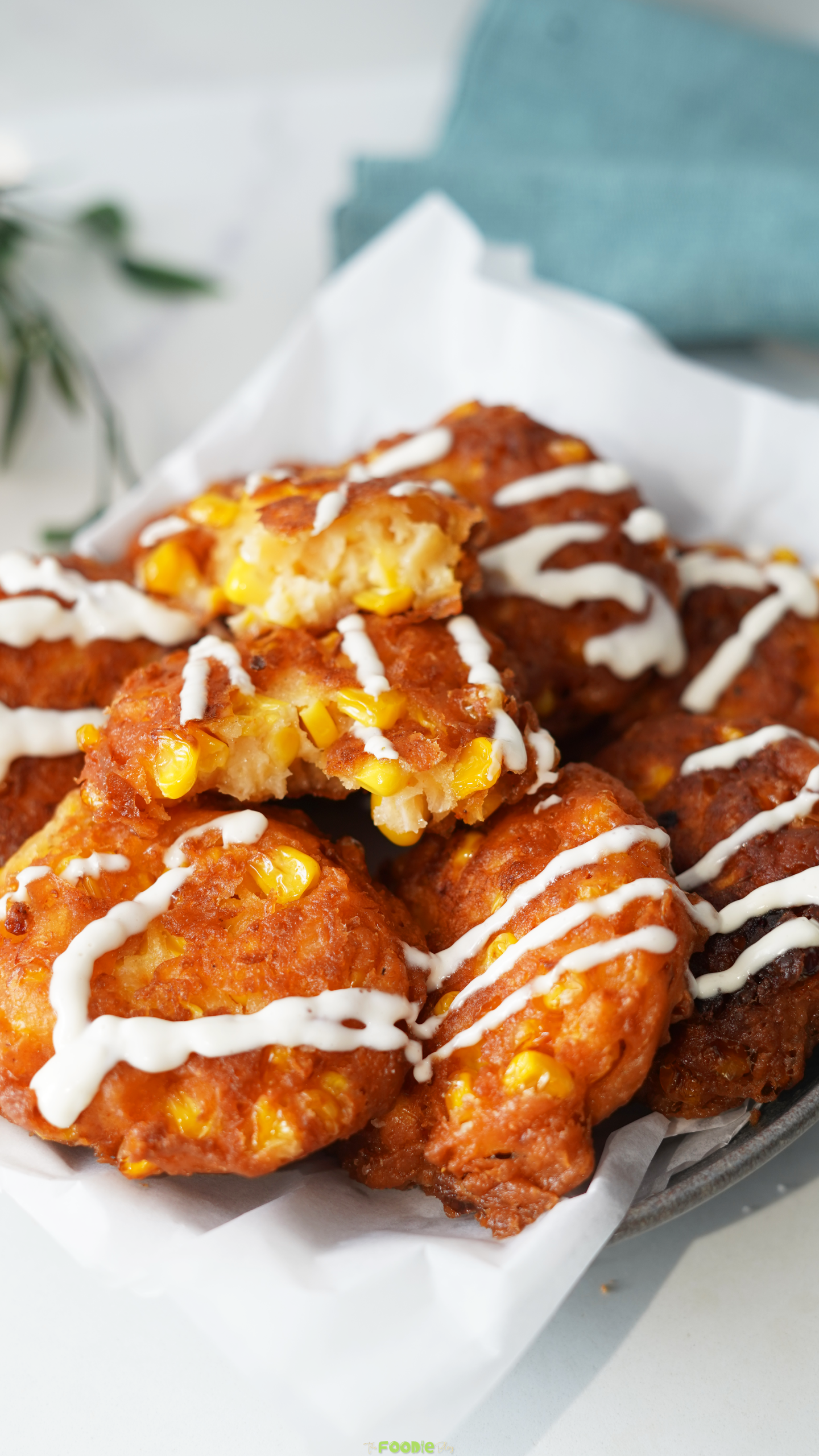 Corn fritter broken open to show a soft center packed with sweet corn